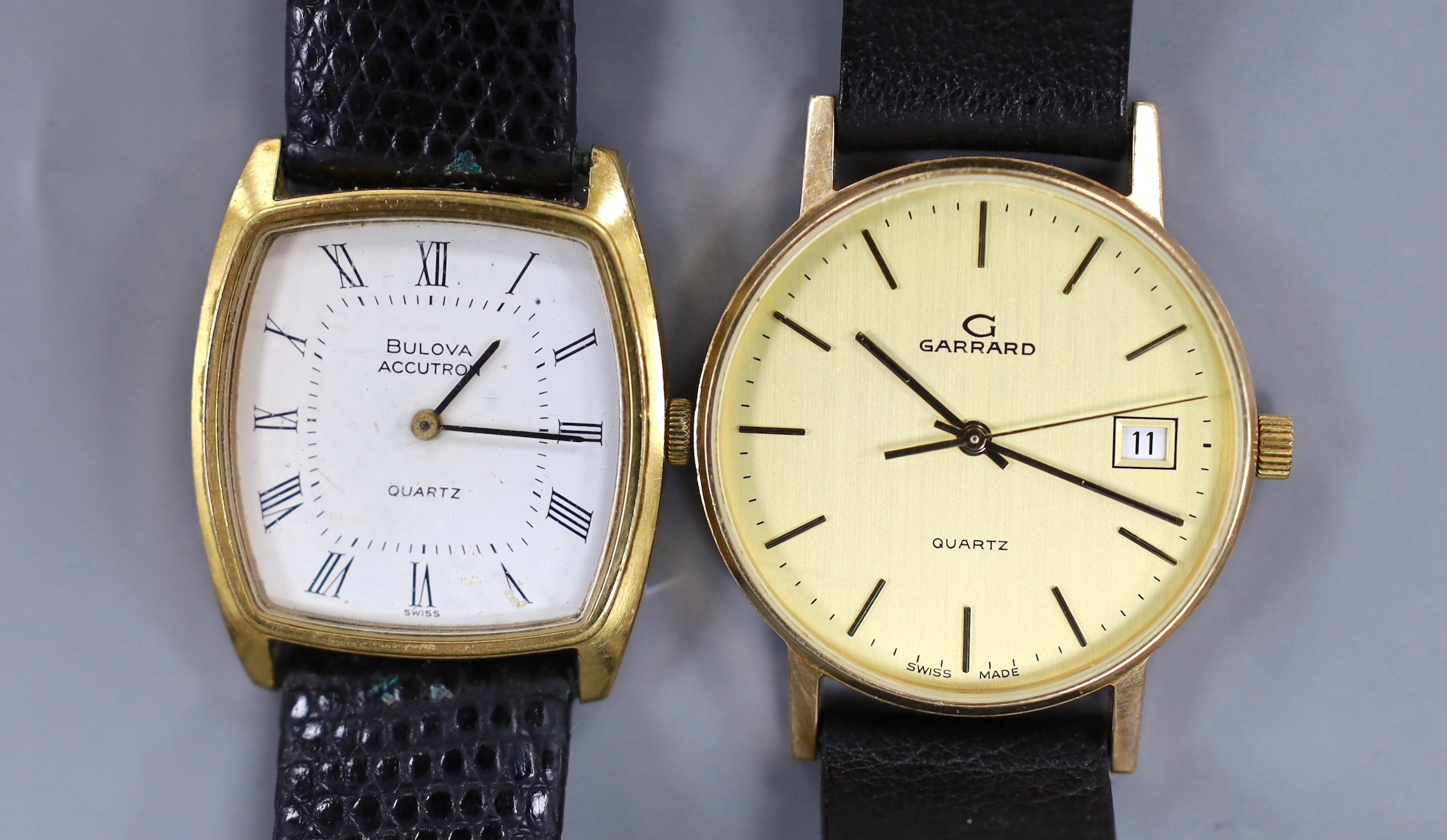 A gentleman's modern gold plated? Garrard quartz wrist watch and a similar steel and gold plated Bulova Accutron quartz wrist watch.